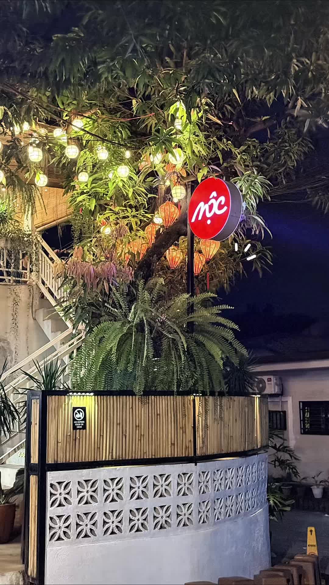 MỘC Cafe exterior at night with lanterns