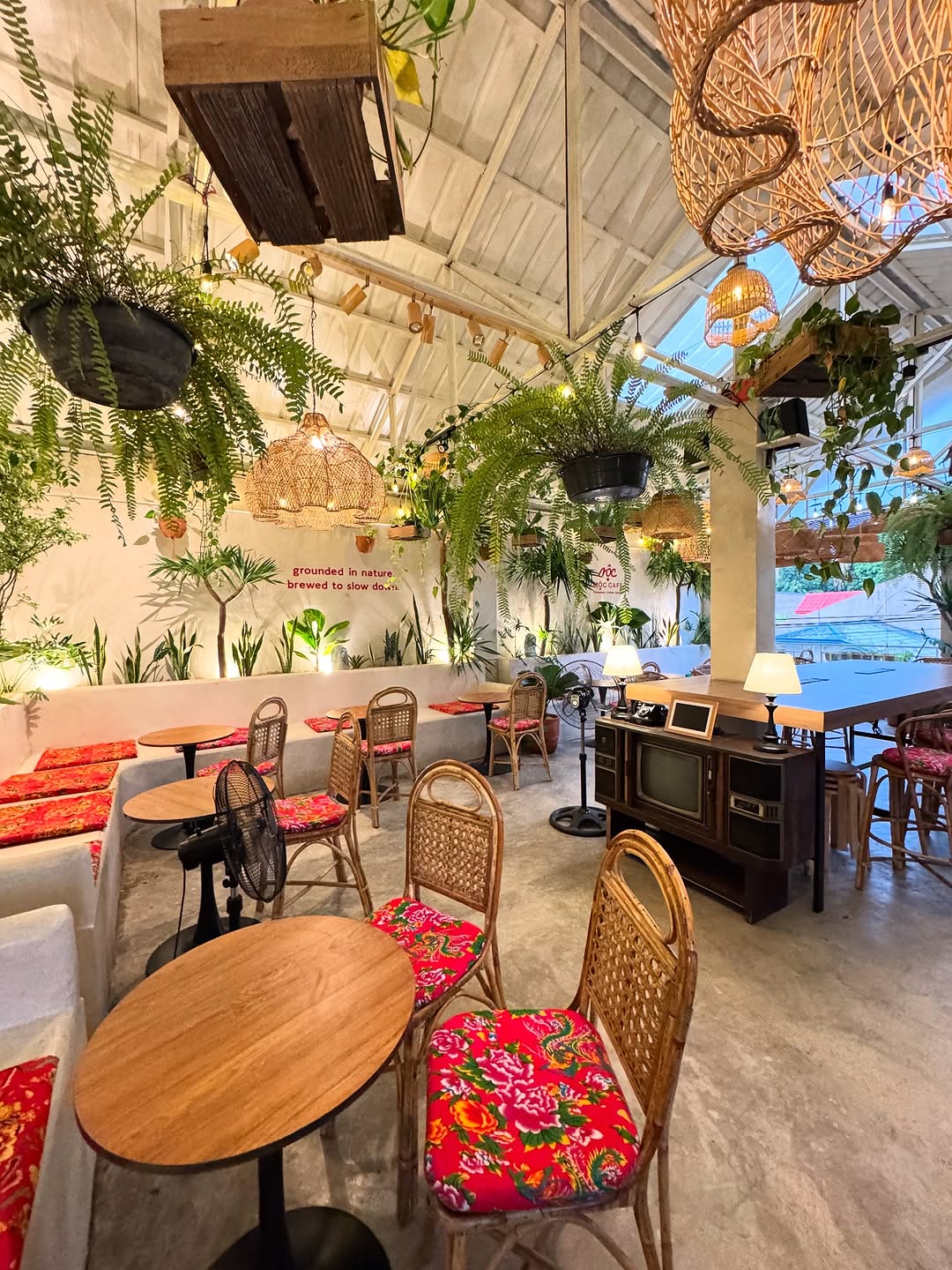 Open air interior at dusk with rattan chairs